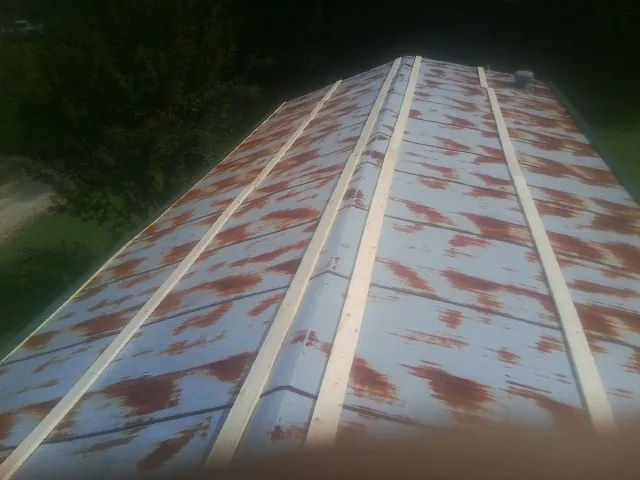 Rusted metal roof panels with new wood purlins before replacement — Storm Damage Roof Repair in Derwood by Roofing Brothers